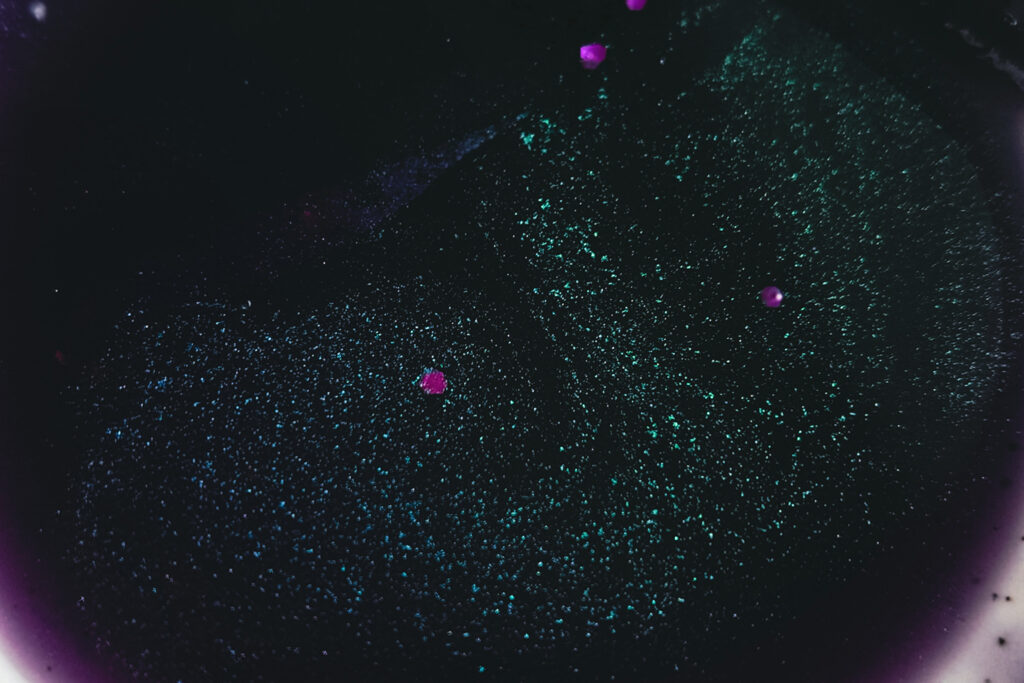 a wax melt melted and shimmering as a pool of melted wax in burner dish