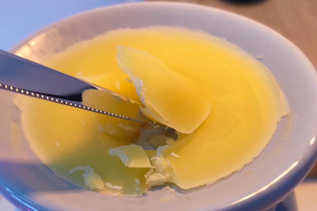 scraping wax melt from burner dish
